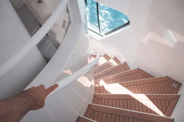A person walking downstairs in the best yachts during cruise.